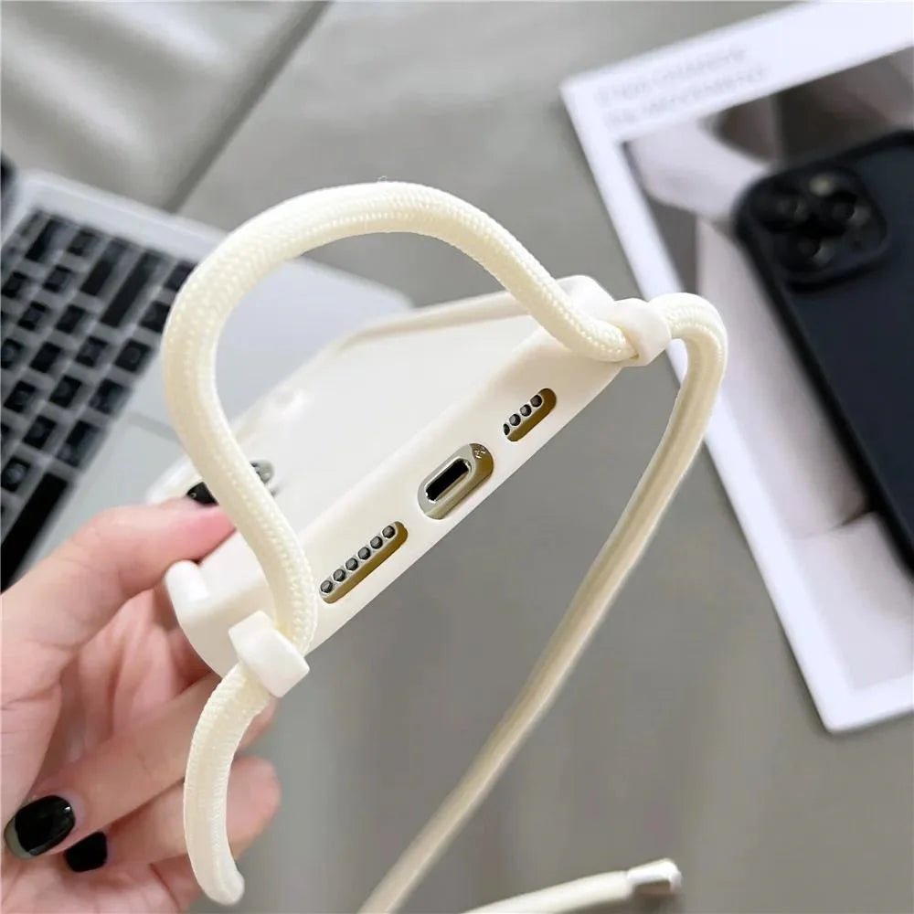 White phone case with ports held by a hand on a blurred office background