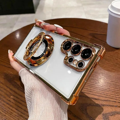 Phone case with gold accents held by a person on a wooden table.