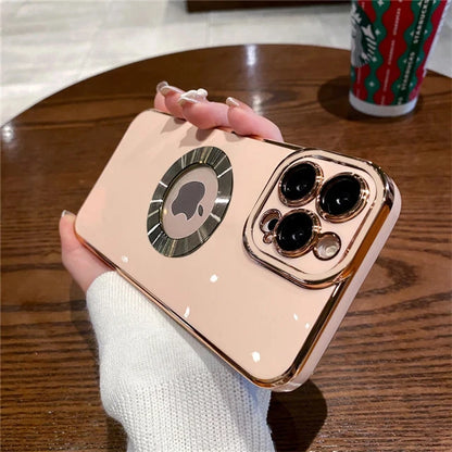 Phone case with rose gold accents held by a hand on a wooden table