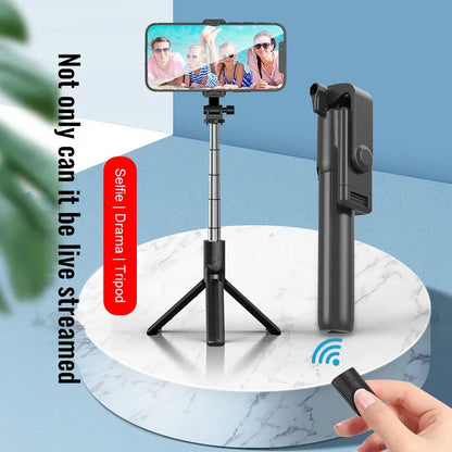 Smartphone with selfie stick and remote control on a white marble surface with blue background