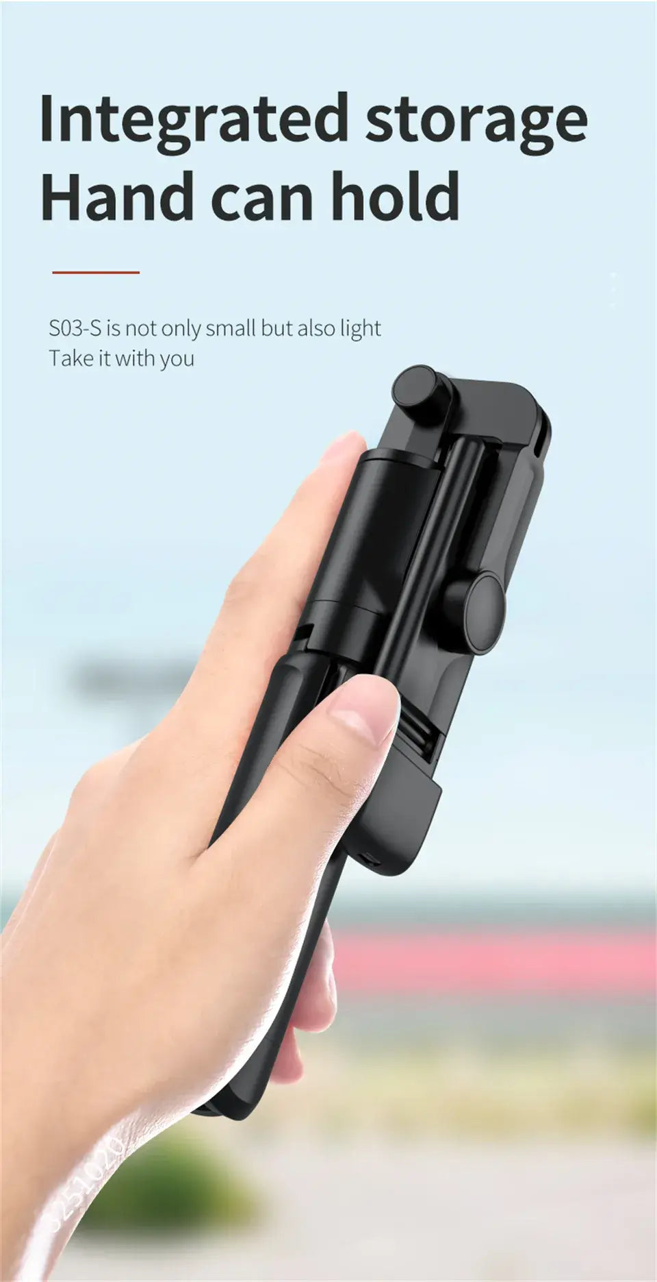 Hand holding a black smartphone selfie stick with text on a light blue background
