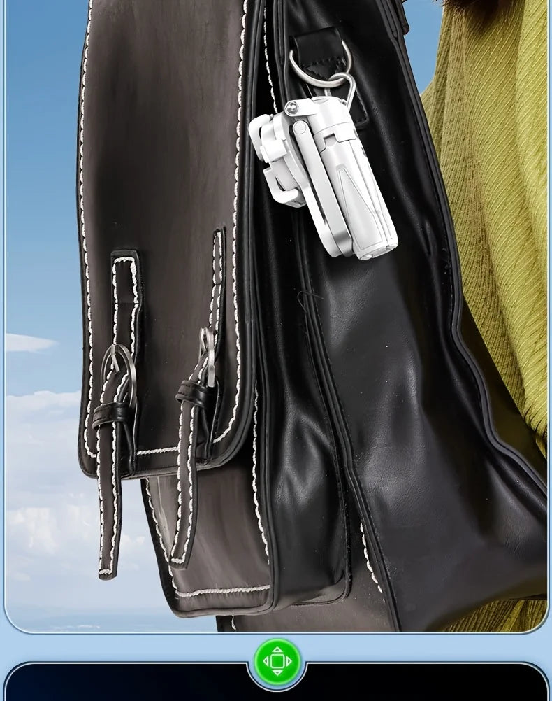 Black leather bag with a white keychain attached, against a blurred background.