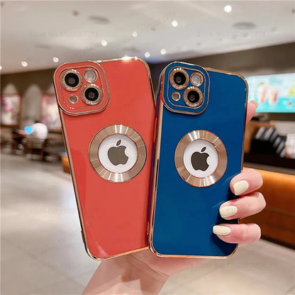 Two phone cases, one red and one blue, with Apple logo, held in a hand.