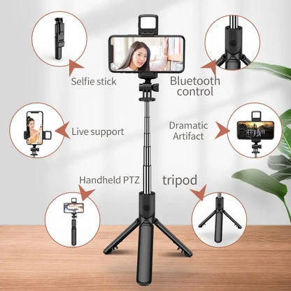 Black selfie stick with smartphone holder on a wooden surface, featuring Bluetooth control and live support functions
