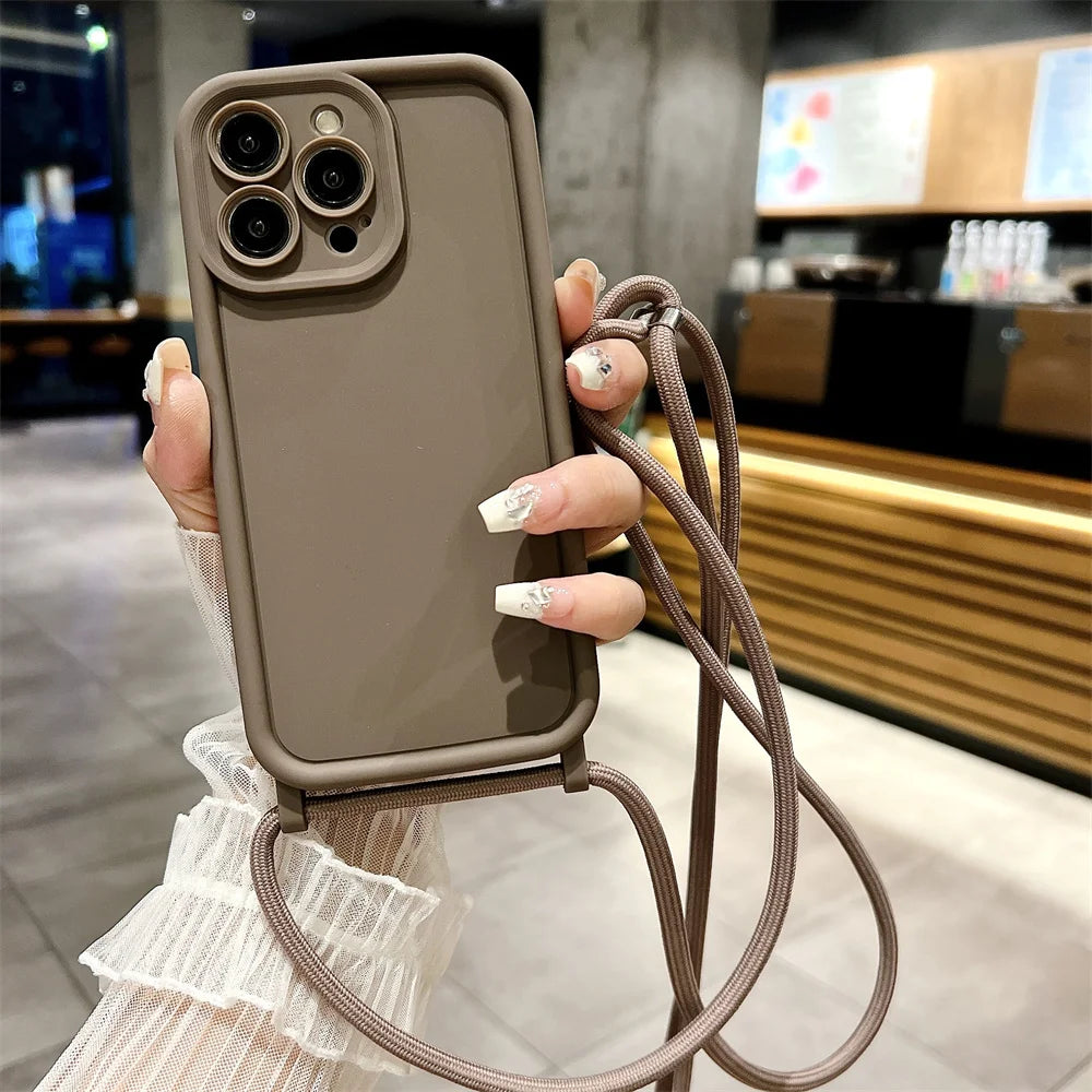 Brown phone case with a strap held by a person in an indoor setting