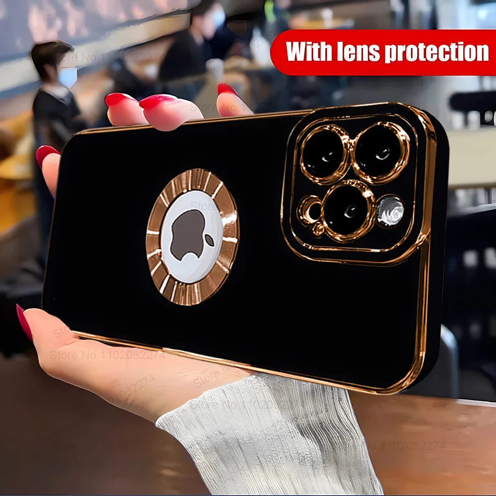 Black phone case with gold accents held by a hand, lens protection feature highlighted.