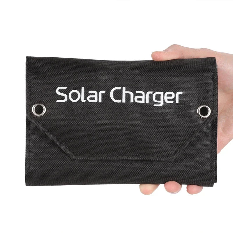 Black solar charger with 'Solar Charger' text held by a hand on a white background