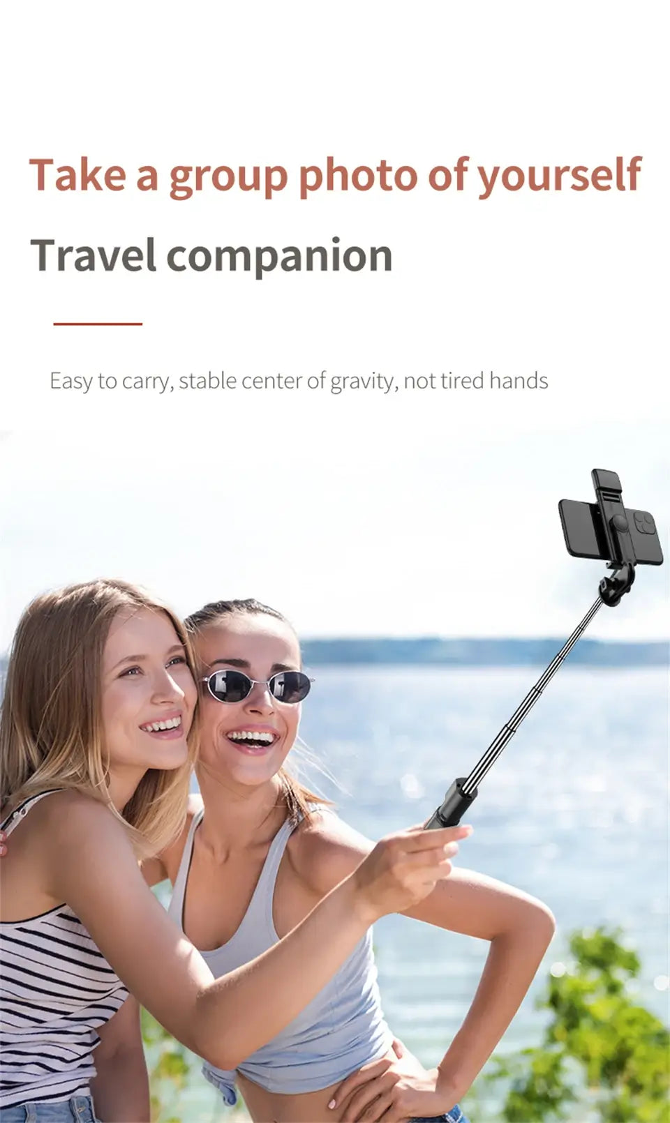 Two women taking a selfie with a travel companion device by the sea
