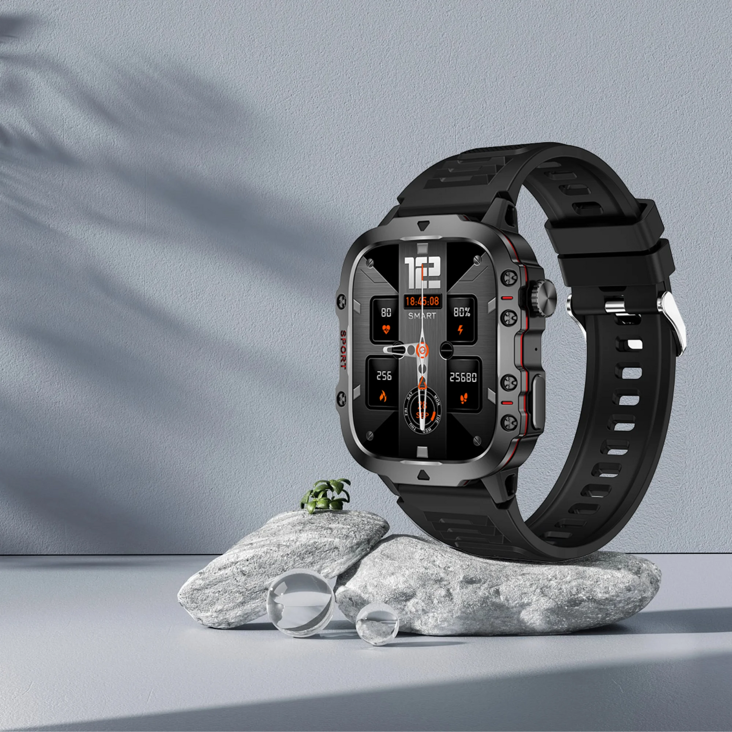 Smartwatch with a black strap on a gray surface with rocks
